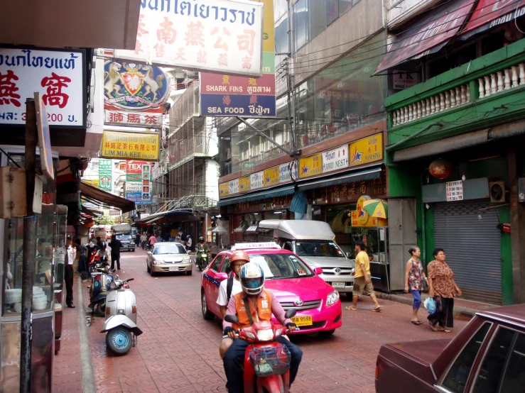 a busy asian city street with people and cars