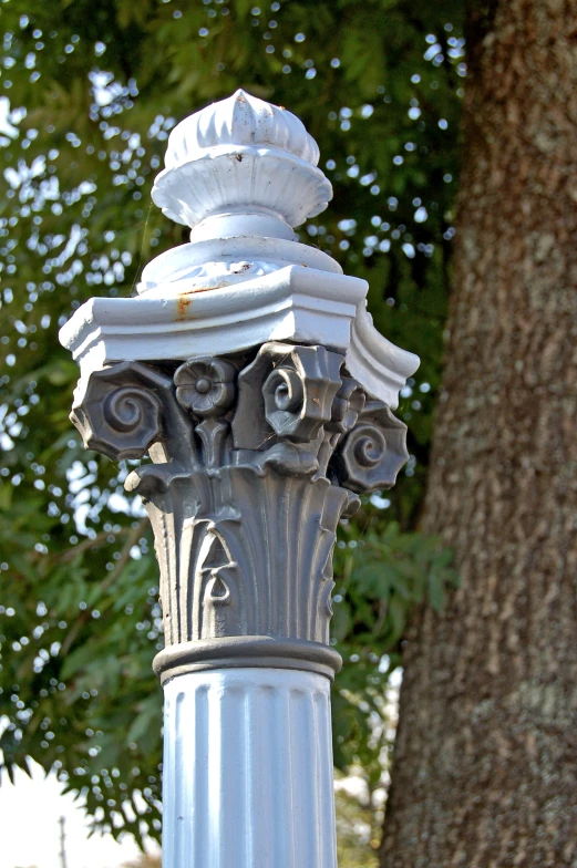 a street light with a tree behind it