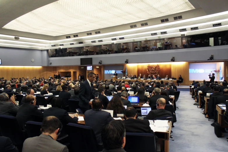 people attending a seminar with lots of laptops