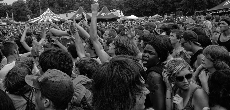 a group of people with their hands up in the air