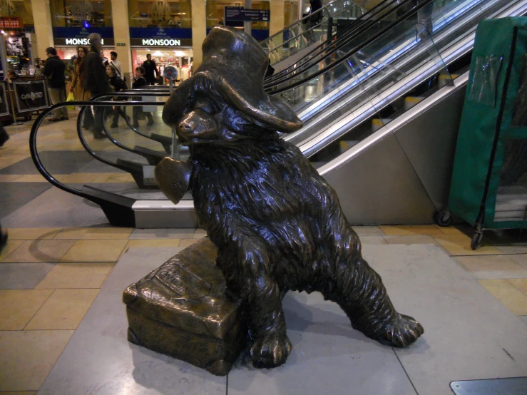 a statue of a bear is standing with his arms folded