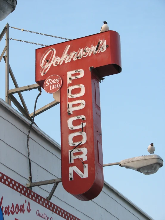 the sign for a restaurant on a roof