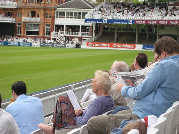 an outdoor stadium filled with people sitting in the seats