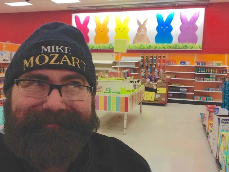 a man with glasses and a hat inside of a store