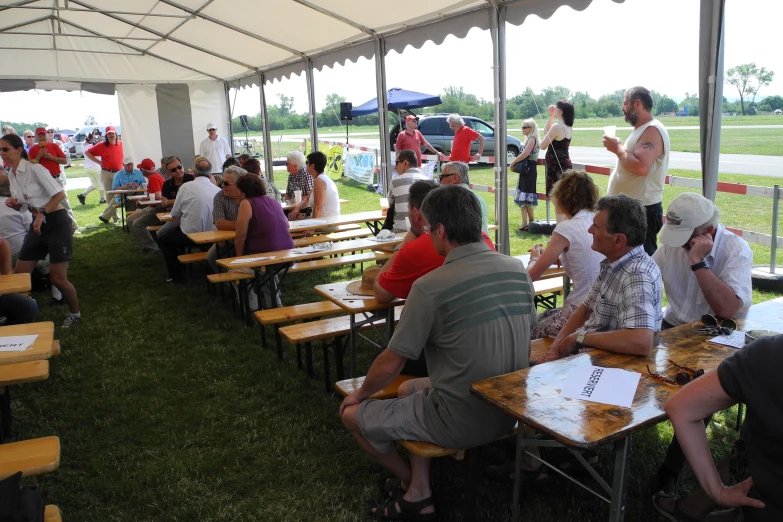 an outside event of people having drinks and eating