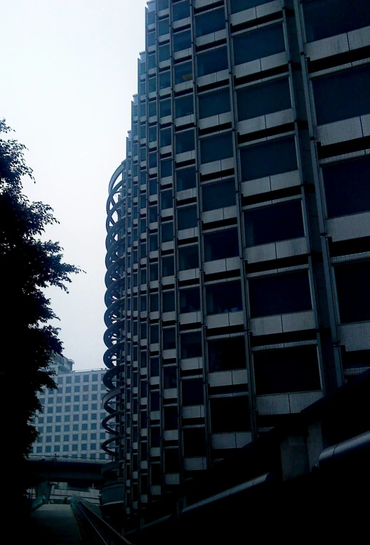 the silhouette of a tall building and a road