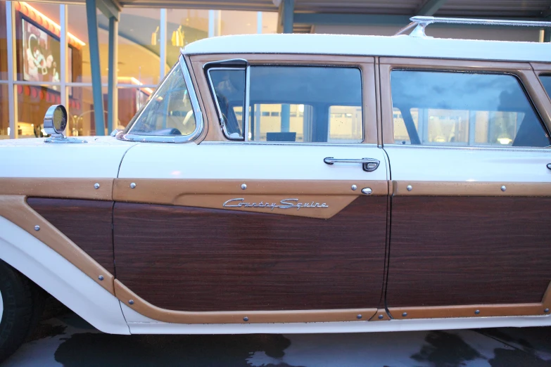 a very old fashion car parked in the snow