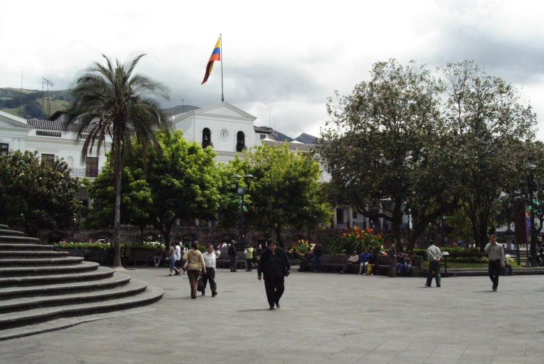 a group of people walking around a plaza