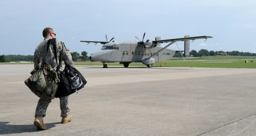 a soldier walking towards an air force plane