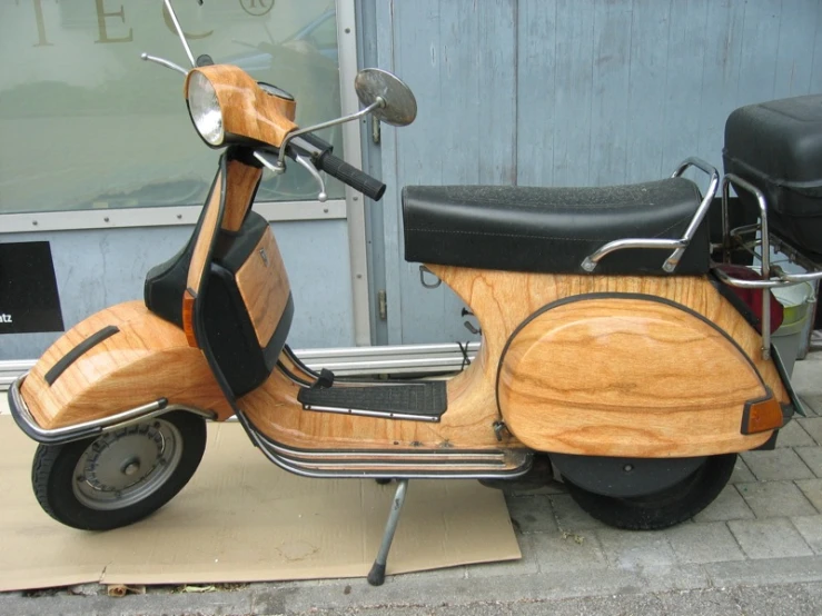 an old motorcycle that is parked near a building