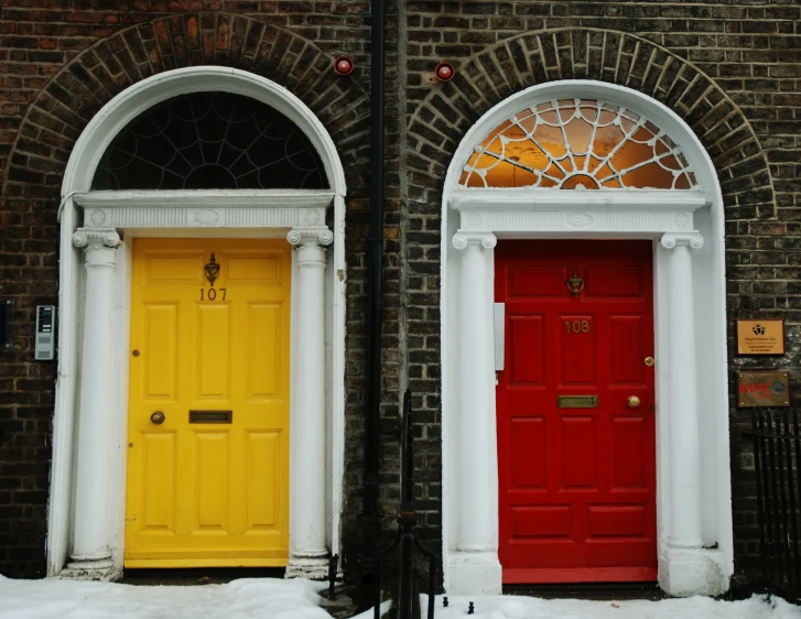 two doors of a house on snowy streets