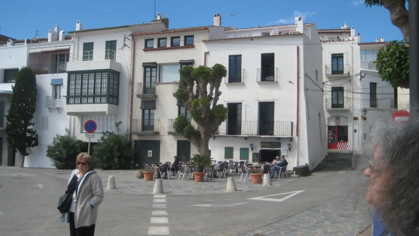 a white building with a group of people in front of it