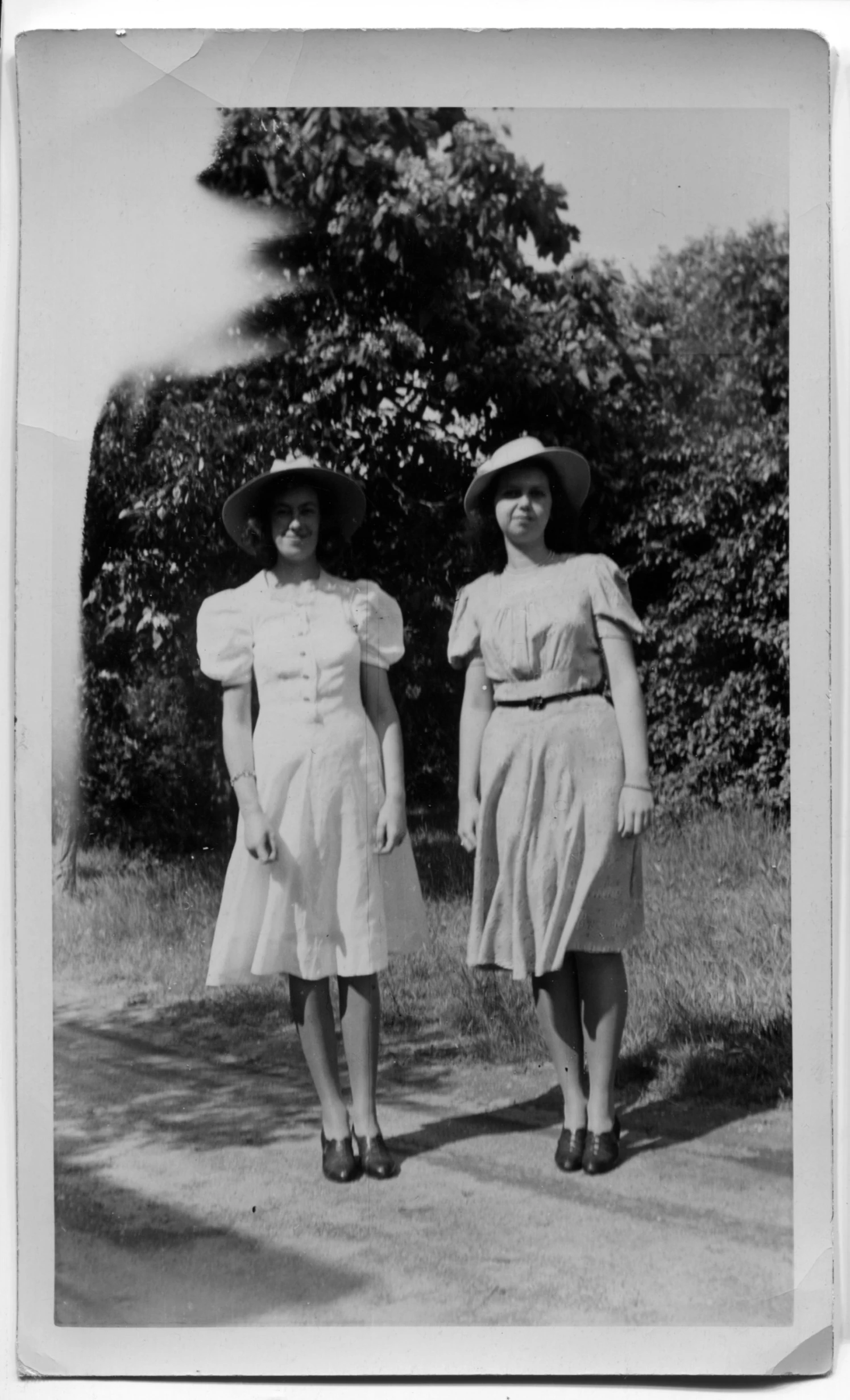 two old time women in dresses and hats