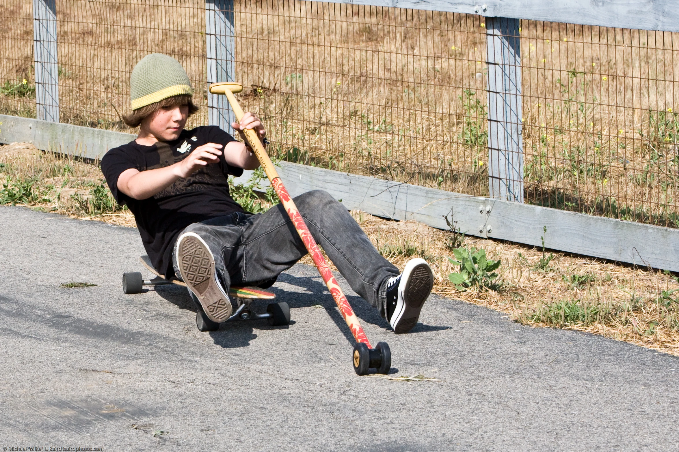 the skateboarder is trying to pull his board behind him