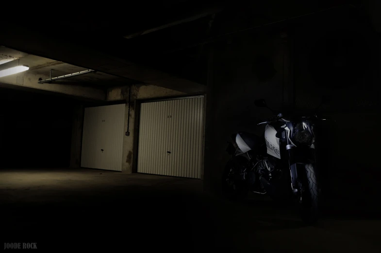 a motorcycle parked in an empty, dark garage