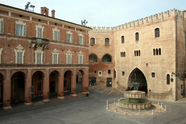 an old building with a fountain in front