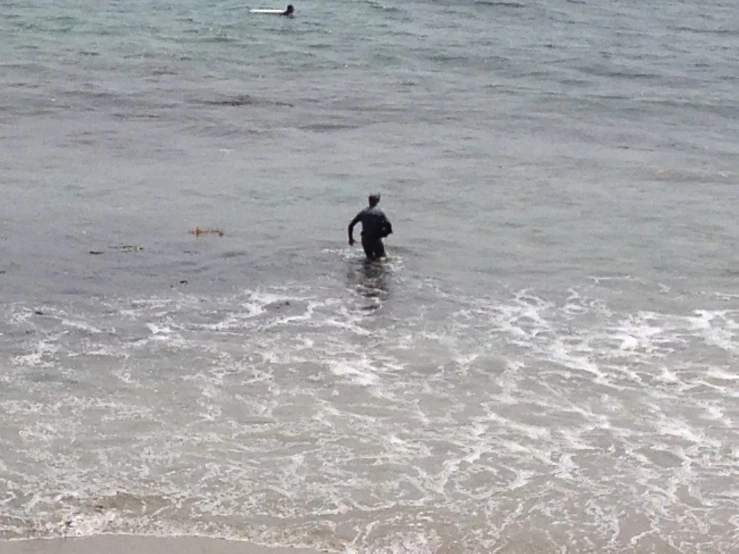 a person swimming in the ocean on a rainy day