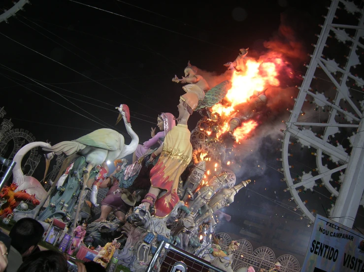 firemen fight with the huge flamingos on this float