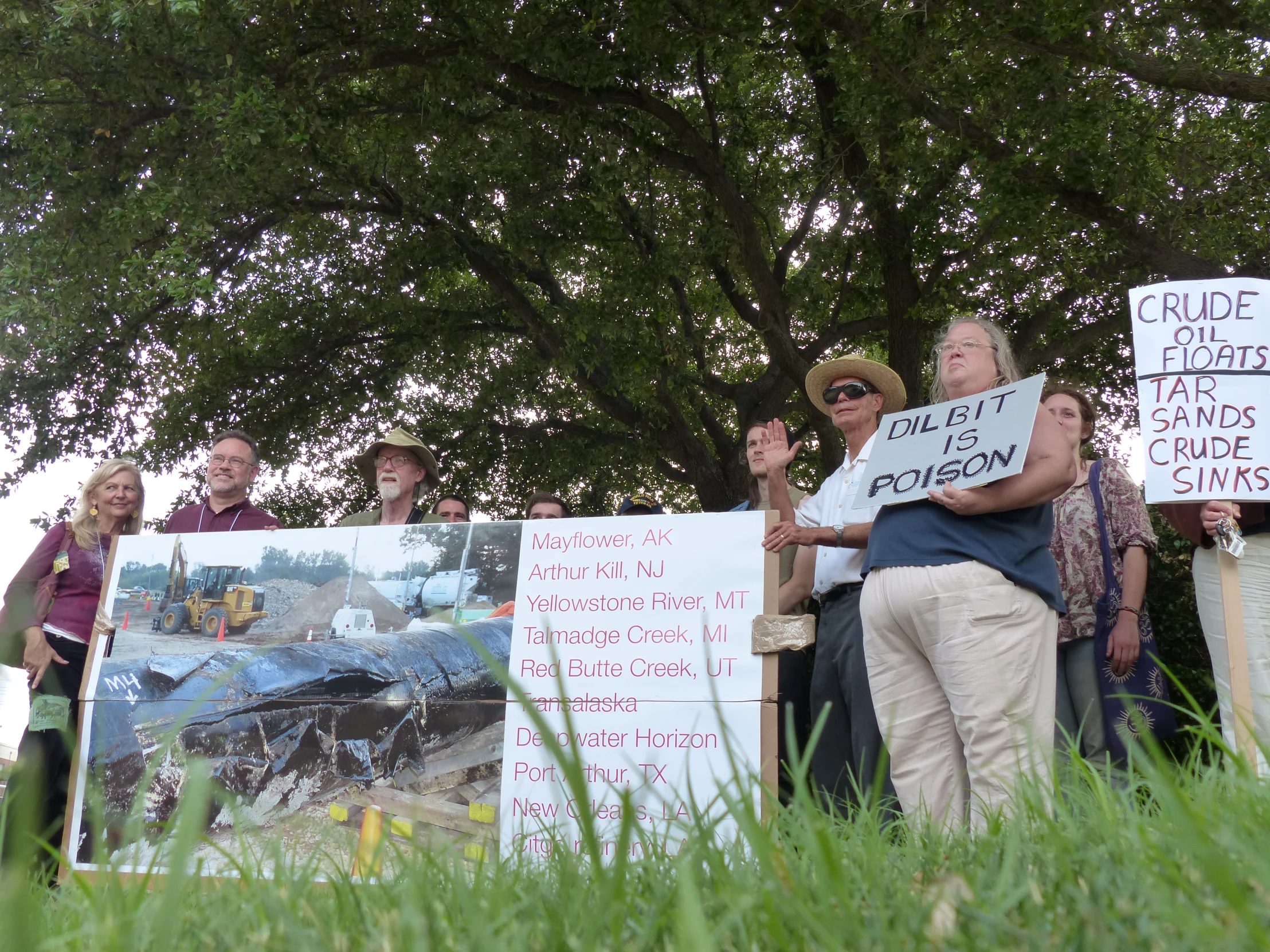 some people standing near signs holding placares