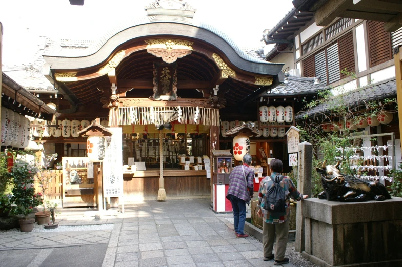 people are shopping outside at a shop in a city