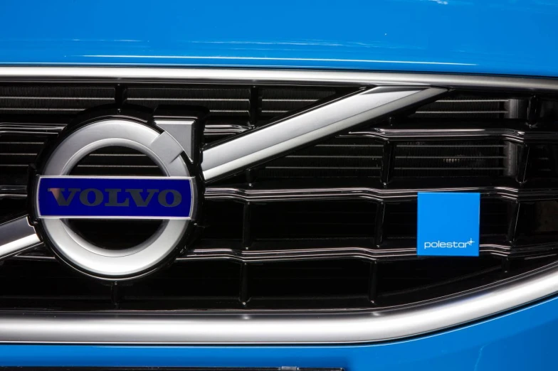 volvo logo on the front grille of a blue car
