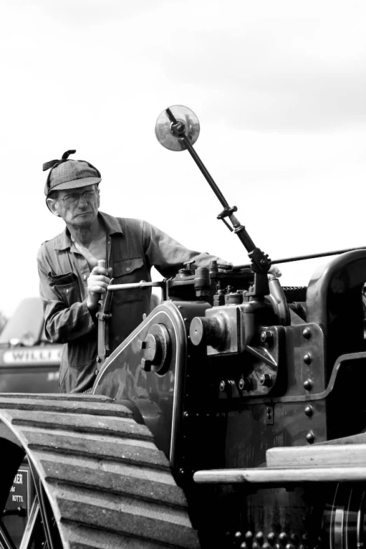 a person with a hat on driving a farm tractor