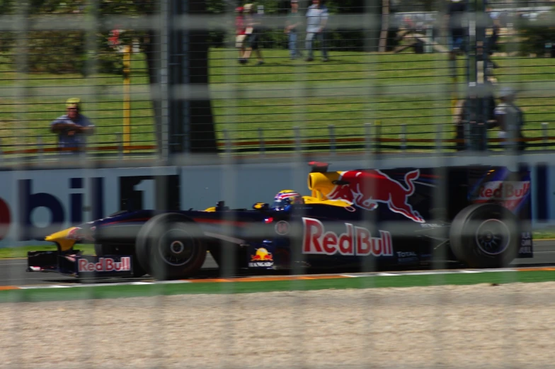 a red bull racing car is turning a corner