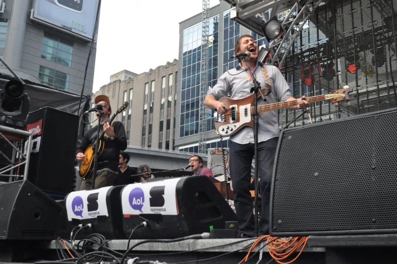 a man with an electric guitar performs at a street festival