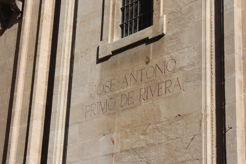 a building has a sign on the wall that reads santa clement in cursive writing