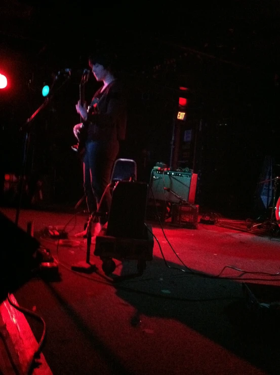 people in a dimly lit concert performing with instruments