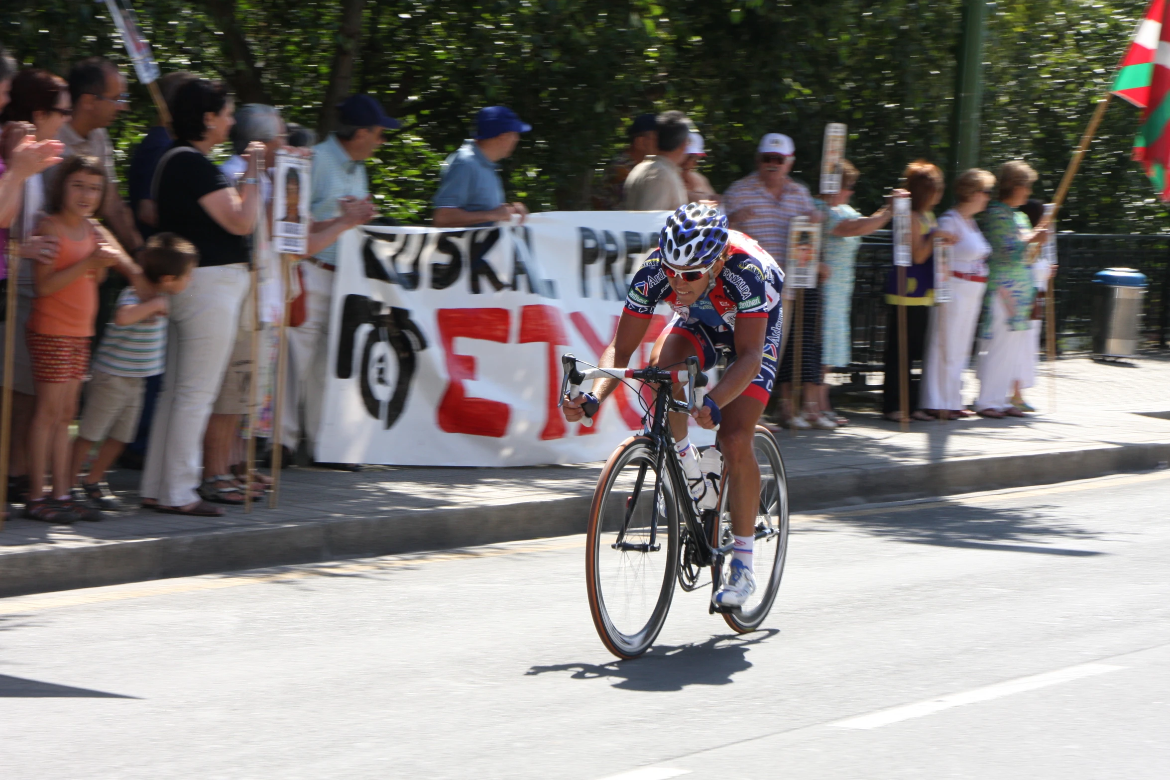 a cyclist is riding in front of spectators