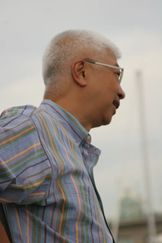 an older man with eye glasses on staring ahead