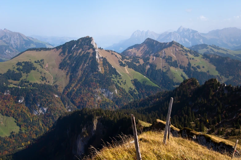 the mountains are dotted with lush grass and trees