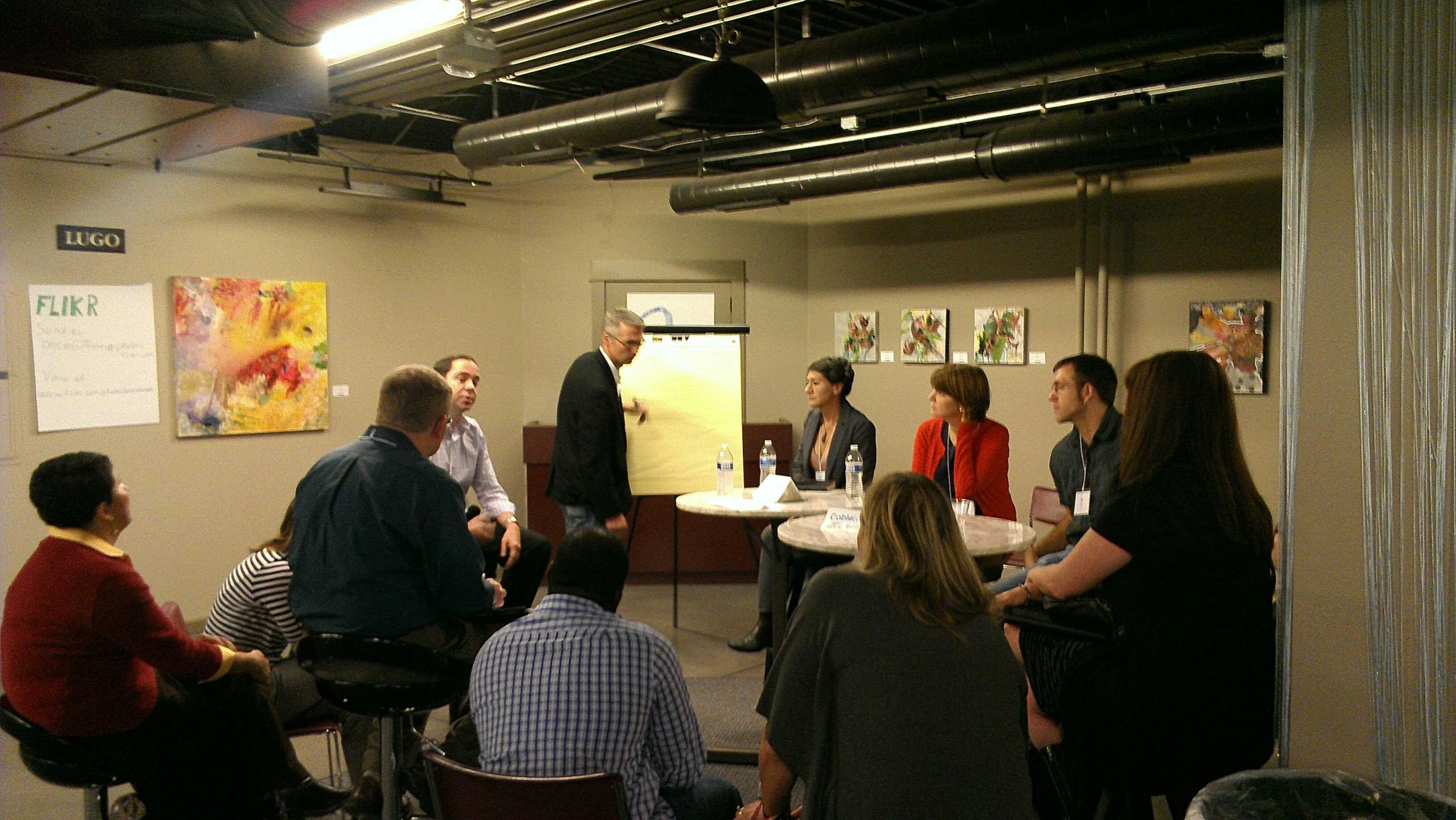 a group of people in an office having a discussion