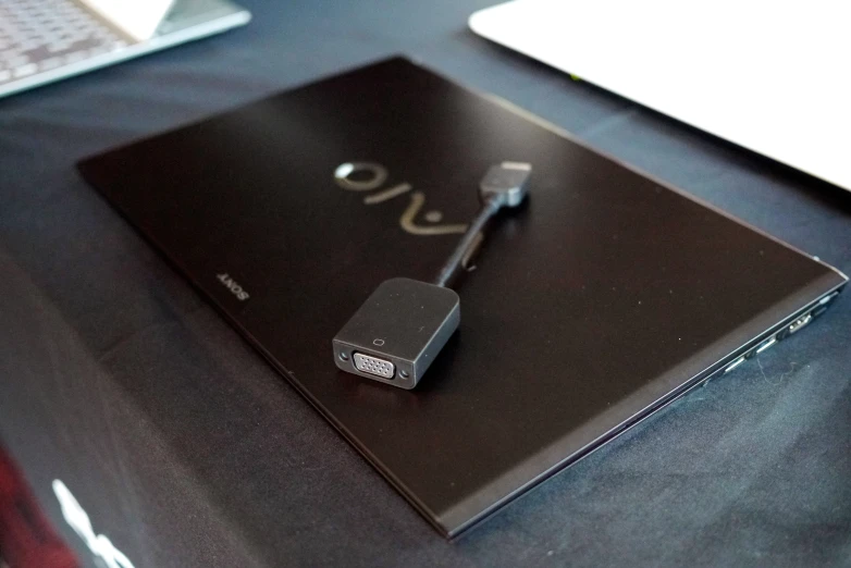 a tablet sitting on top of a desk with usb plugged into it