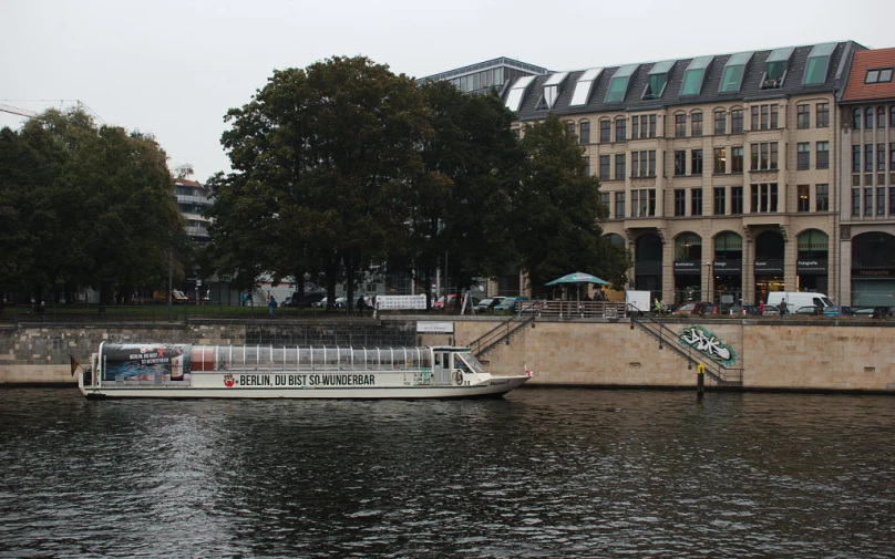 a white boat floating next to a large building