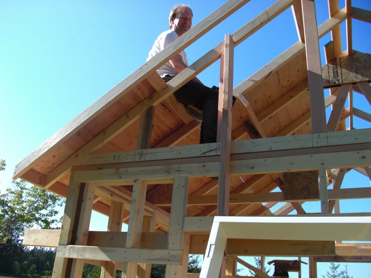 a person standing on top of a house