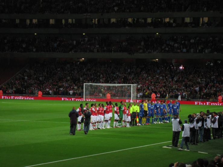 the soccer team is lined up at the end of the field