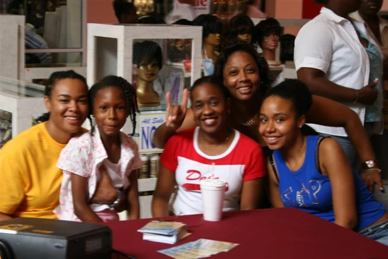 people sitting at a table posing for a picture