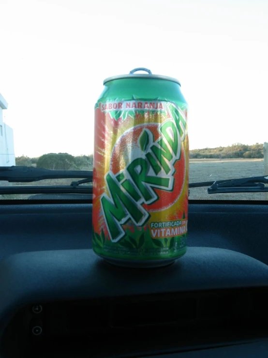 a can of canned soft drink sitting in the middle of a car