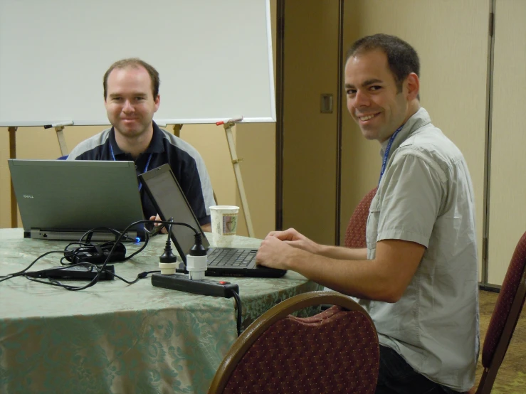 a man in front of a laptop computer with a male