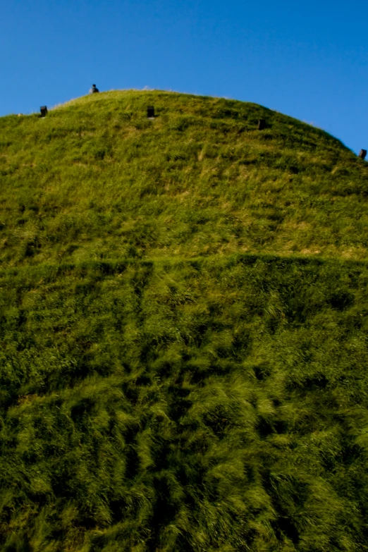 a big hill that is made out of grass