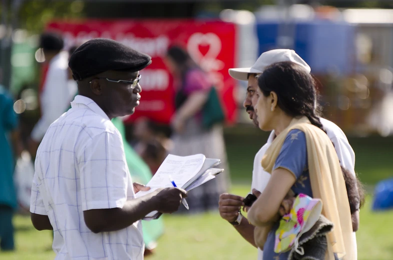 two people are talking on the grassy field