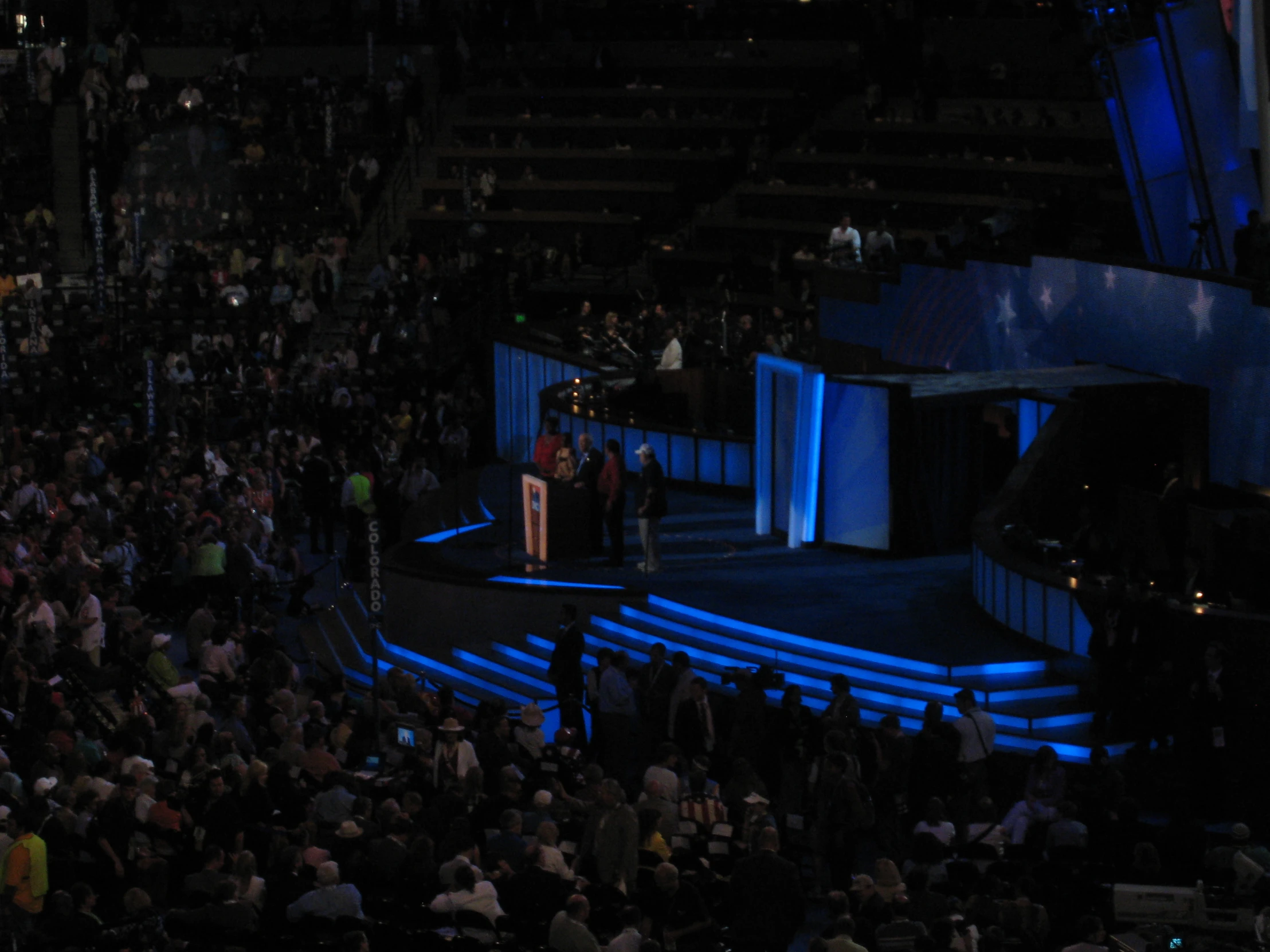 a man standing on top of a stage while someone addresses