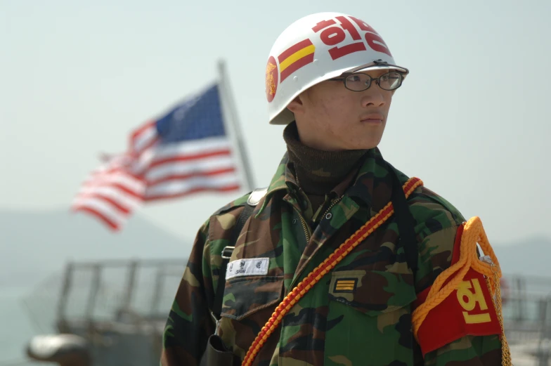 a military soldier with flags in the background