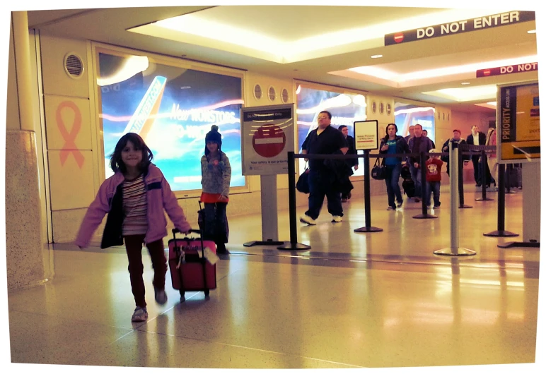 a girl with luggage walks through the hallway