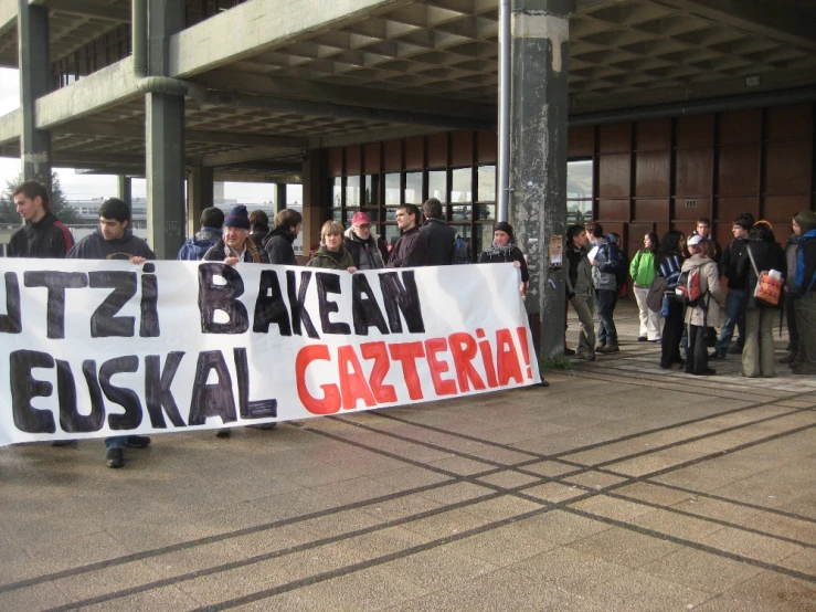 people holding a large sign with an israeli word