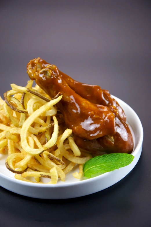 a plate topped with french fries covered in sauce