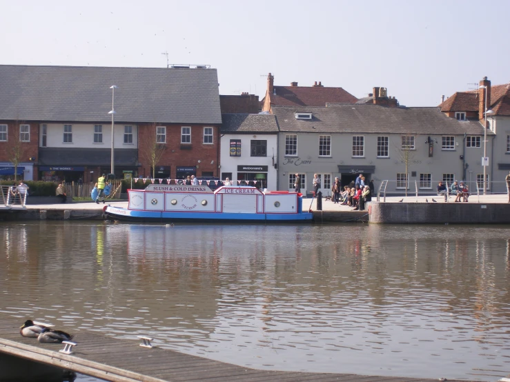 a small blue and red boat floating in a river