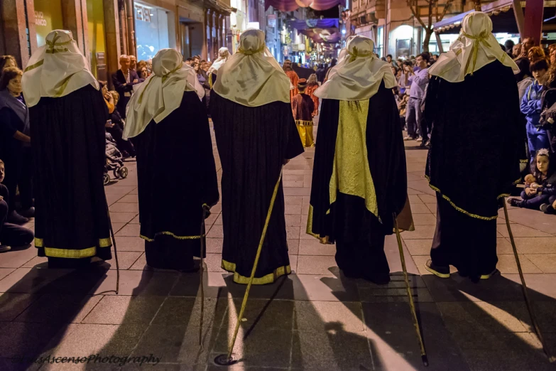 four statues standing in the middle of a busy street